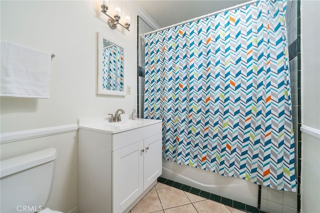 full bathroom with tile patterned flooring, vanity, toilet, crown molding, and shower / bath combo with shower curtain