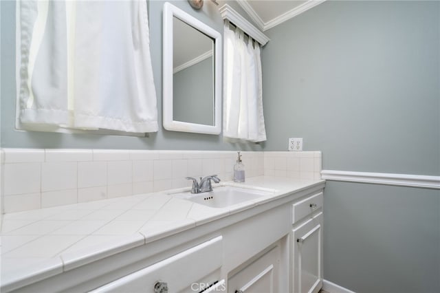 bathroom with crown molding and vanity