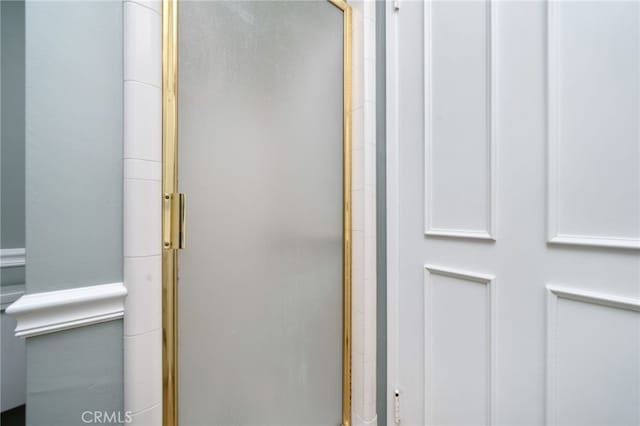 bathroom with a shower with door