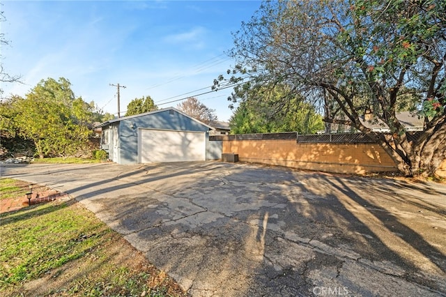 view of side of home with a garage and an outdoor structure