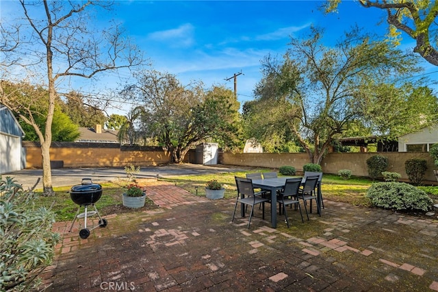 view of patio featuring a storage unit