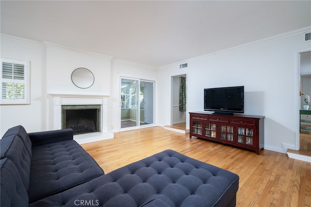 living room featuring ornamental molding and wood-type flooring