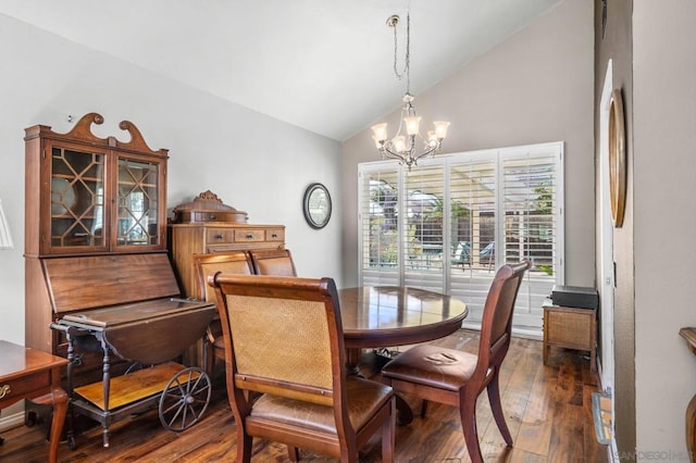 dining room featuring lofted ceiling, dark hardwood / wood-style floors, and an inviting chandelier