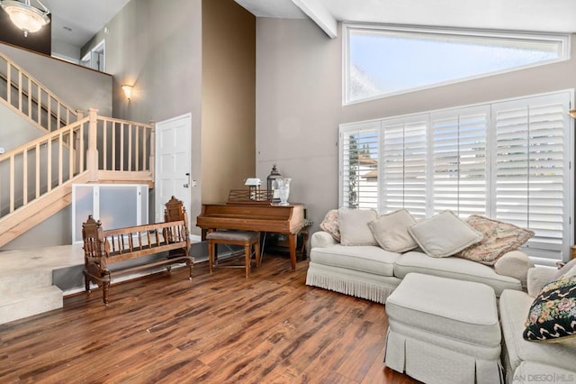 living room featuring beamed ceiling, high vaulted ceiling, and hardwood / wood-style floors