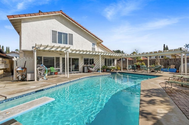 view of swimming pool featuring a diving board, a patio area, and a pergola