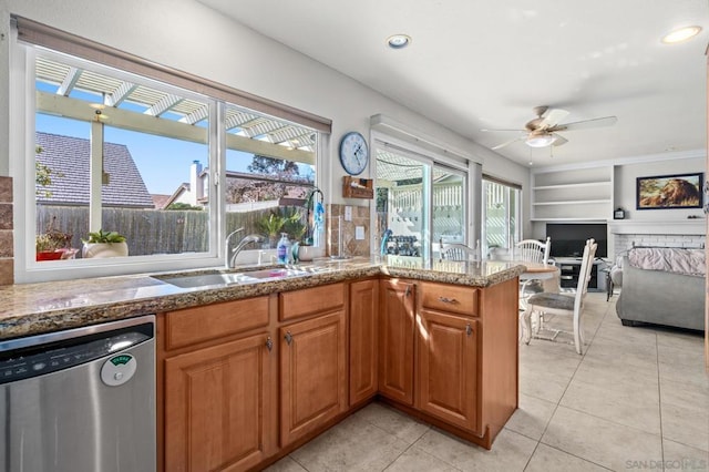 kitchen featuring sink, light tile patterned floors, dishwasher, ceiling fan, and built in shelves