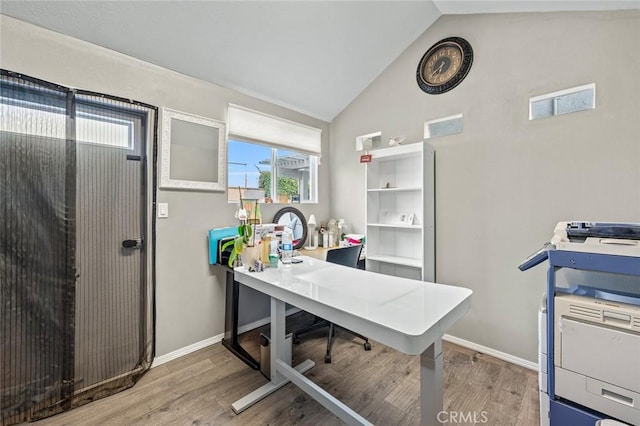 home office with vaulted ceiling and wood-type flooring