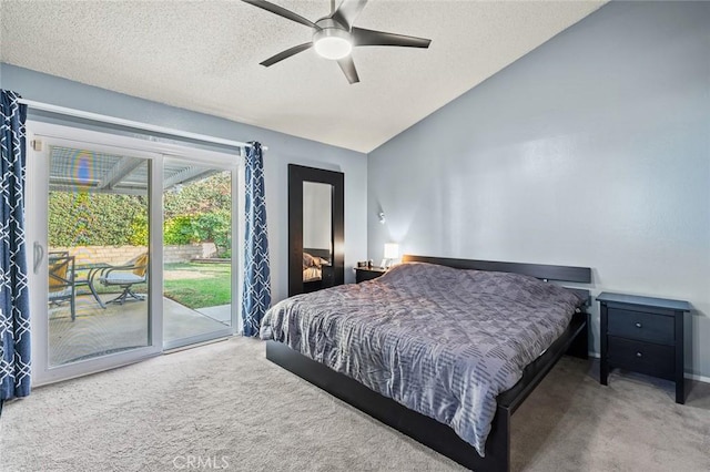 bedroom featuring ceiling fan, vaulted ceiling, carpet floors, a textured ceiling, and access to outside