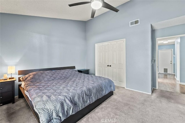 carpeted bedroom featuring a closet and ceiling fan