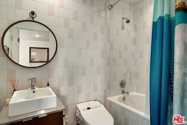 full bathroom featuring shower / tub combo with curtain, vanity, toilet, and tile walls