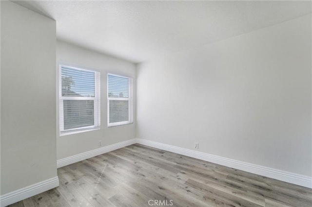 spare room featuring light hardwood / wood-style floors