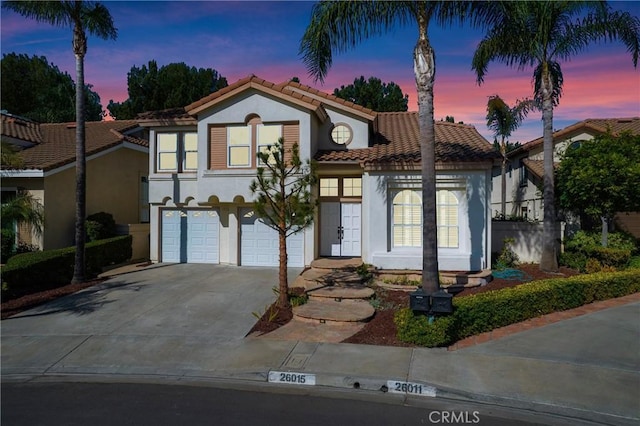 mediterranean / spanish-style home featuring a garage