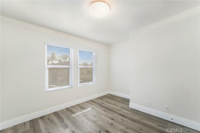 unfurnished room with hardwood / wood-style floors