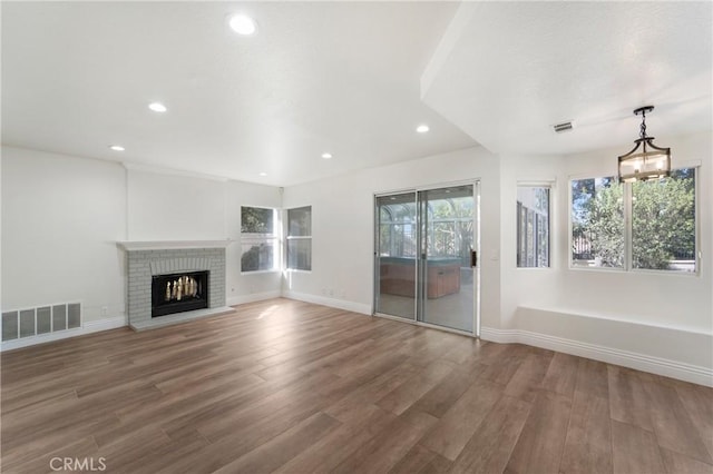 unfurnished living room featuring hardwood / wood-style flooring and a fireplace