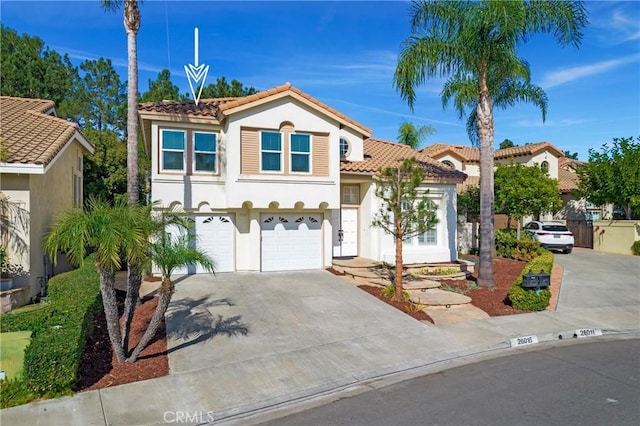 mediterranean / spanish-style house with a garage