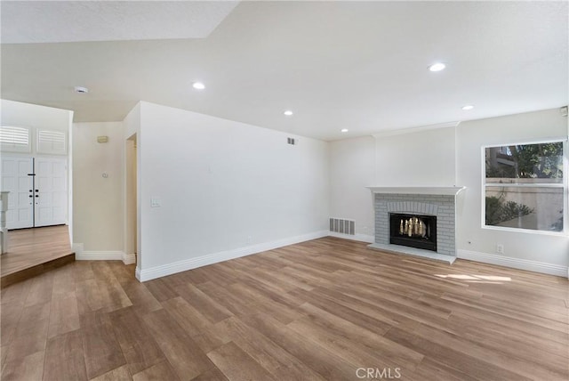 unfurnished living room featuring a fireplace and light hardwood / wood-style flooring