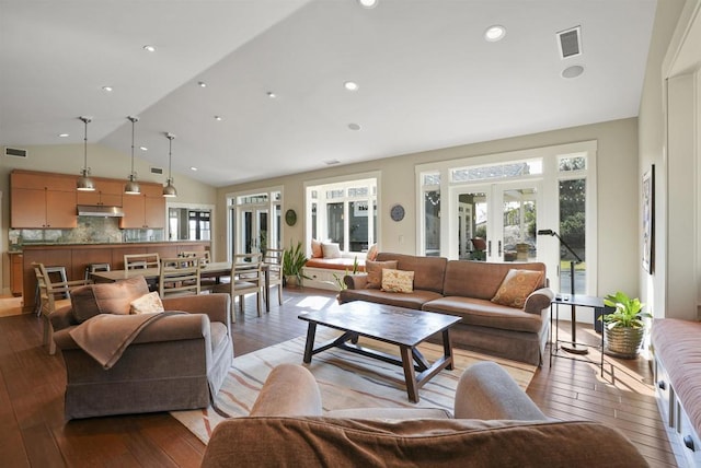 living room with french doors, lofted ceiling, and light hardwood / wood-style flooring