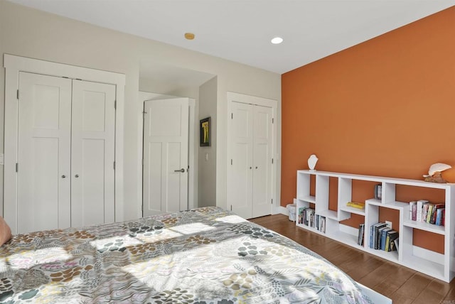 bedroom with dark hardwood / wood-style flooring