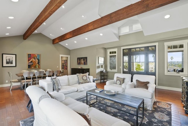 living room featuring hardwood / wood-style flooring and vaulted ceiling with beams