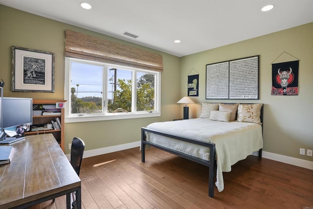 bedroom with dark hardwood / wood-style floors