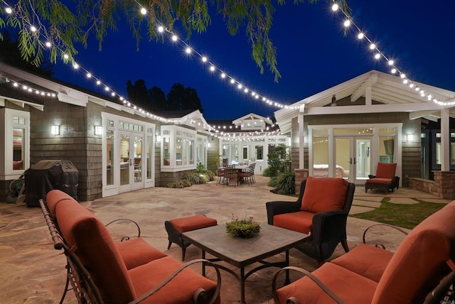 patio at twilight featuring french doors and grilling area