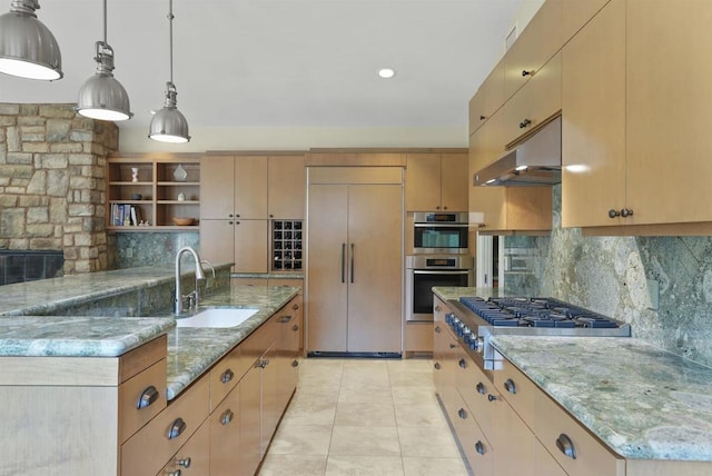 kitchen with decorative light fixtures, sink, stainless steel appliances, light stone countertops, and light brown cabinets