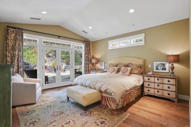 bedroom with vaulted ceiling, hardwood / wood-style floors, access to exterior, and french doors