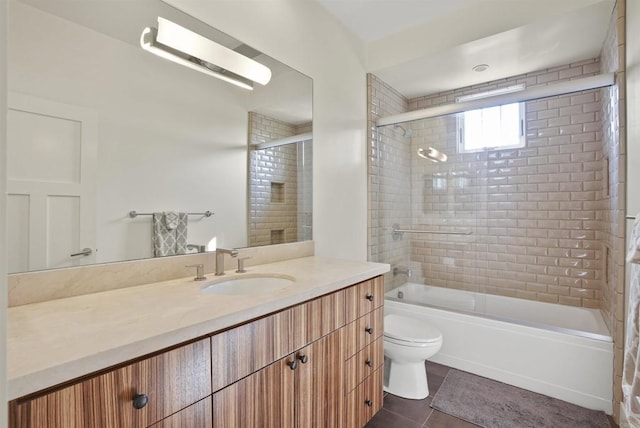 full bathroom featuring shower / bath combination with glass door, tile patterned floors, toilet, and vanity