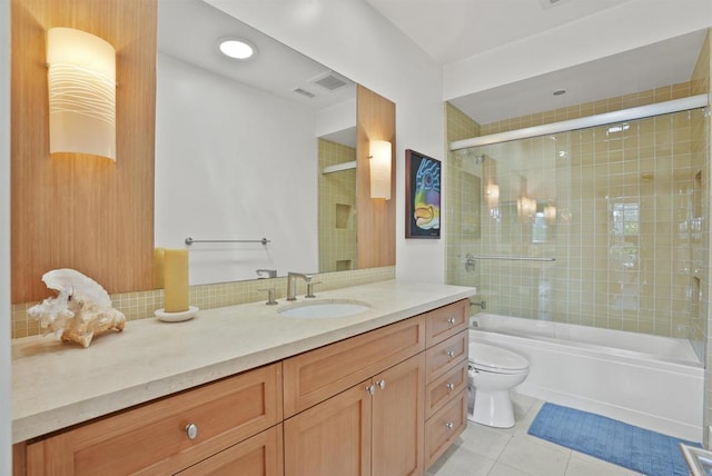 full bathroom with tile patterned flooring, enclosed tub / shower combo, vanity, and toilet