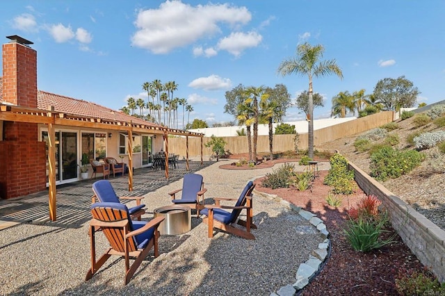 view of yard featuring a fenced backyard, a patio, and a fire pit