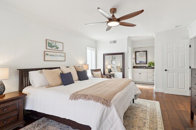 bedroom with multiple windows, dark wood finished floors, visible vents, and crown molding