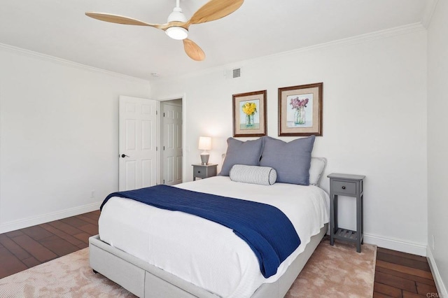 bedroom featuring wood-type flooring, crown molding, and baseboards