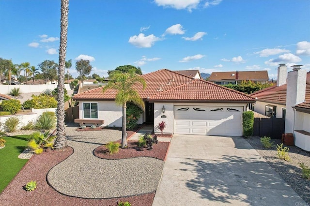 view of front facade featuring driveway, a tile roof, an attached garage, fence, and stucco siding