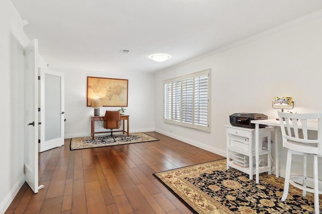 office space with crown molding, visible vents, hardwood / wood-style flooring, and baseboards