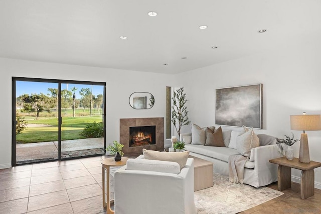 living room with a tile fireplace and light tile patterned floors