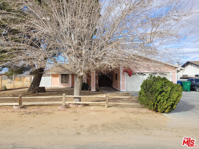 view of property hidden behind natural elements with a garage