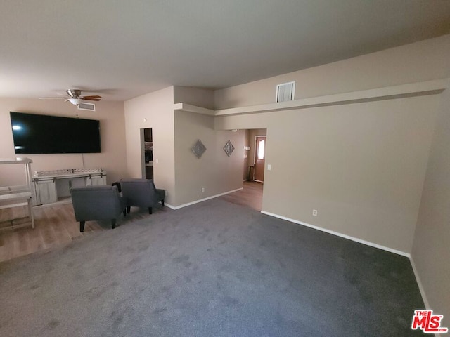 unfurnished living room featuring carpet floors and ceiling fan