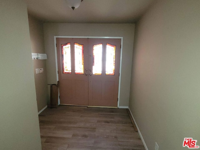 entryway featuring hardwood / wood-style flooring and french doors