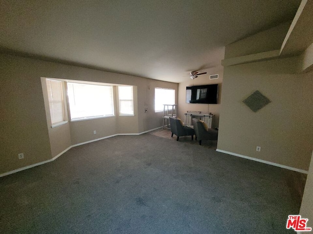 interior space with ceiling fan and carpet floors