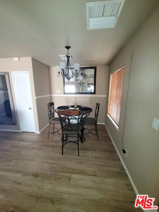 dining area with a chandelier and hardwood / wood-style floors