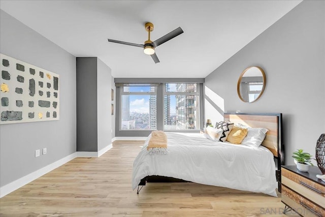 bedroom with light hardwood / wood-style floors and ceiling fan