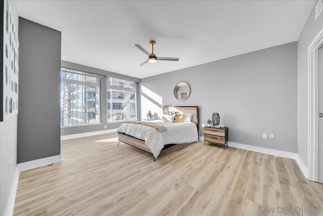 bedroom with light hardwood / wood-style flooring and ceiling fan