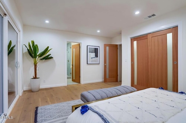 bedroom with light wood-type flooring and a closet