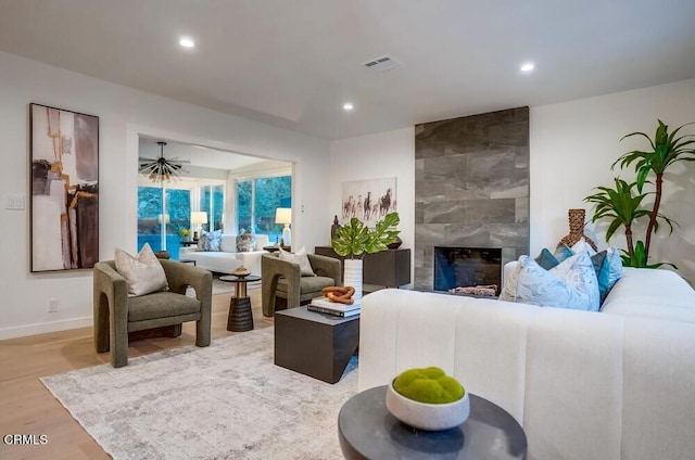 living room with a premium fireplace and light hardwood / wood-style floors