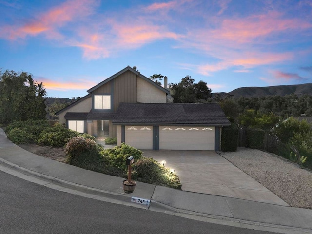 view of front of house with a garage and a mountain view