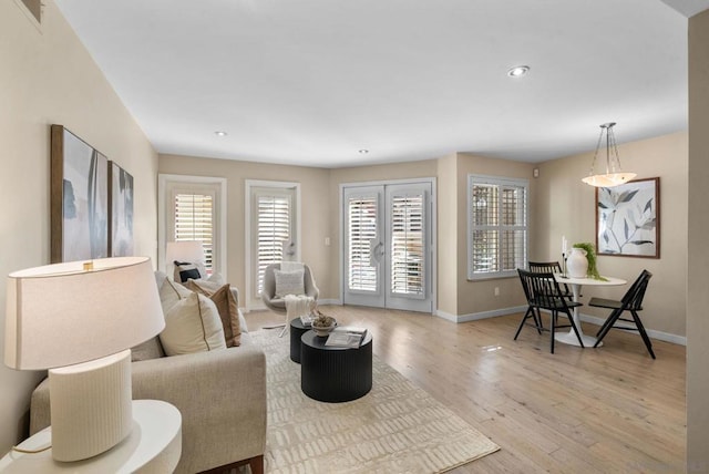 living room featuring light wood-type flooring and french doors