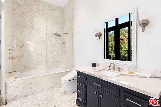 full bathroom with vanity, toilet, and tiled shower / bath combo