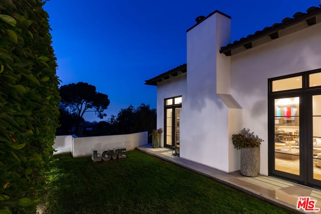 view of yard featuring french doors