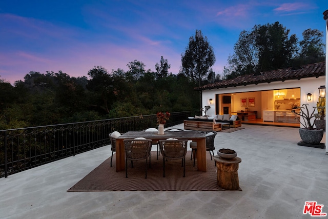 patio terrace at dusk with an outdoor living space