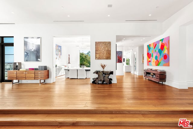 interior space featuring hardwood / wood-style flooring and a notable chandelier